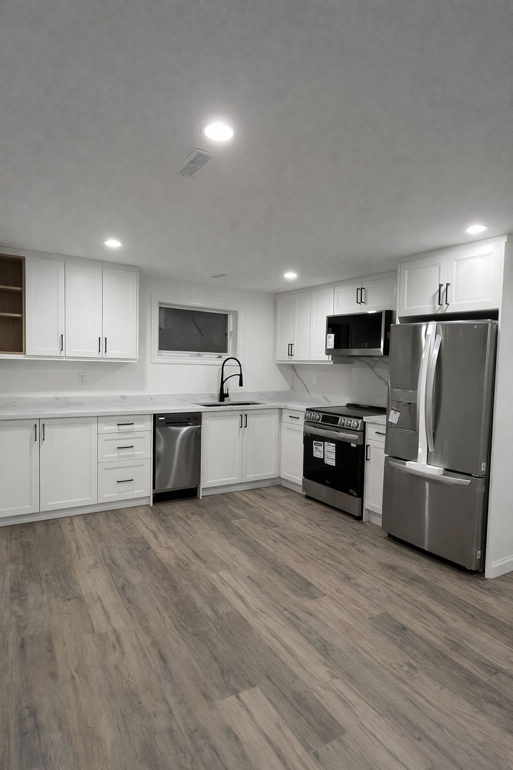 Basement kitchenette renovation with compact cabinetry and quartz counter