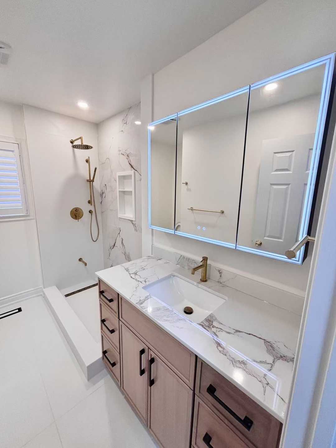 Black kodaen fixture with grey tone of tile and vanity,