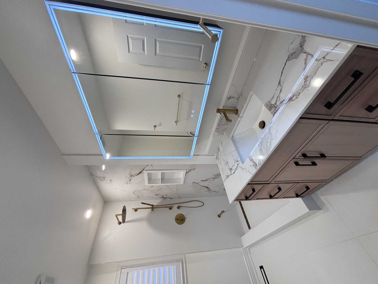 Black kodaen fixture with grey tone of tile and vanity,