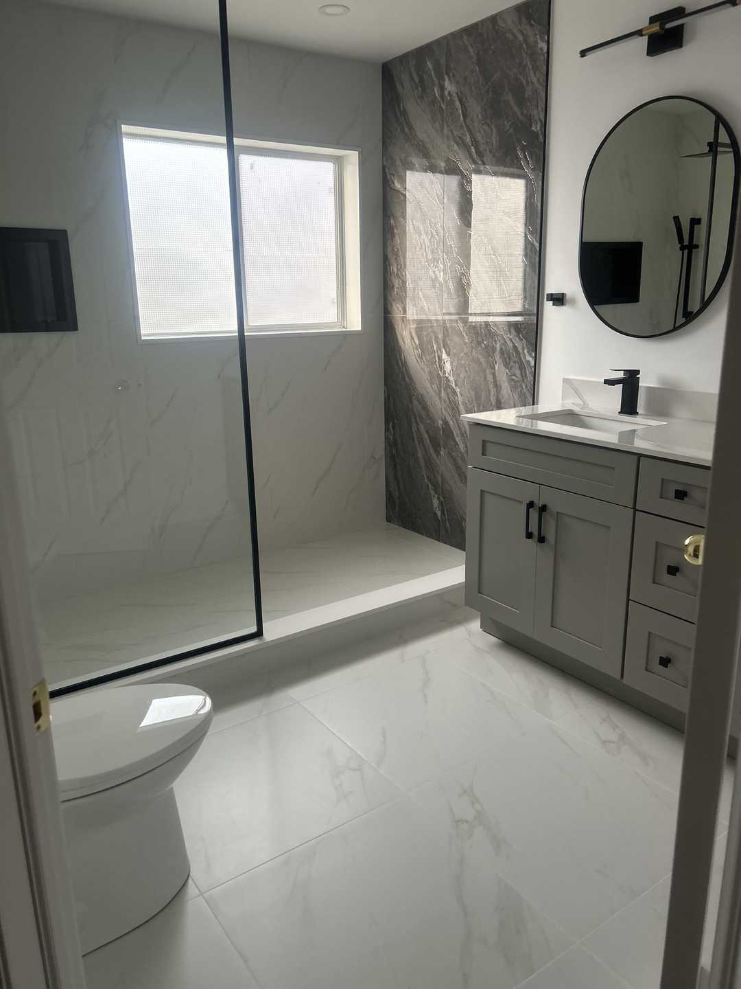 Grey vanity with black kodaen fixture, custom black U-shaped groove