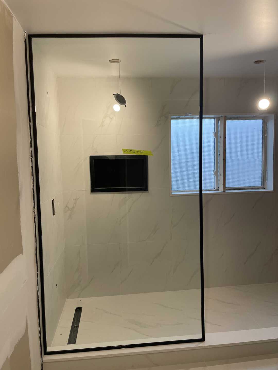 Grey vanity with black kodaen fixture, custom black U-shaped groove