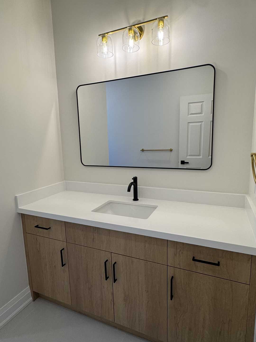 32"*32" grey tile with black riobel fixture, custom vanity, arch