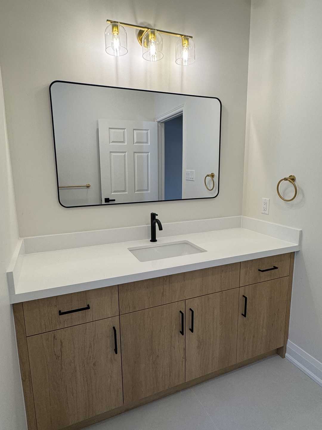 32"*32" grey tile with black riobel fixture, custom vanity, arch