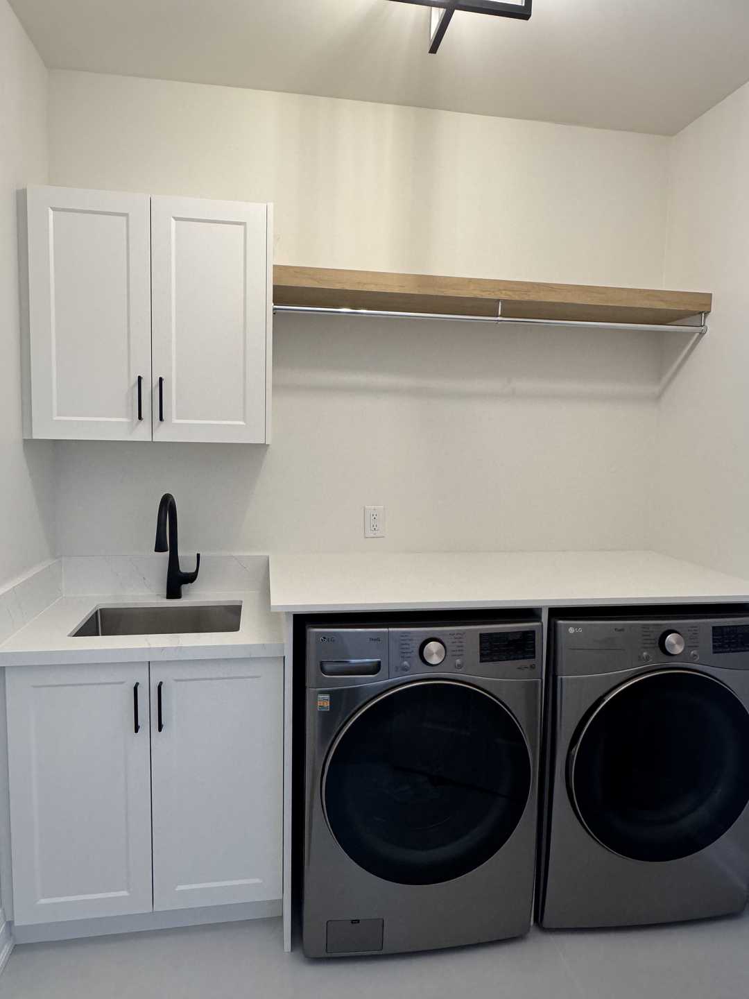 32"*32" grey tile with black riobel fixture, custom vanity, arch