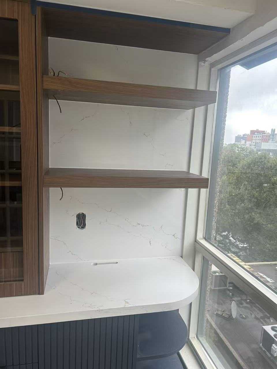 walnut wood panel with navy blue fluted kitchen, herringbone oak