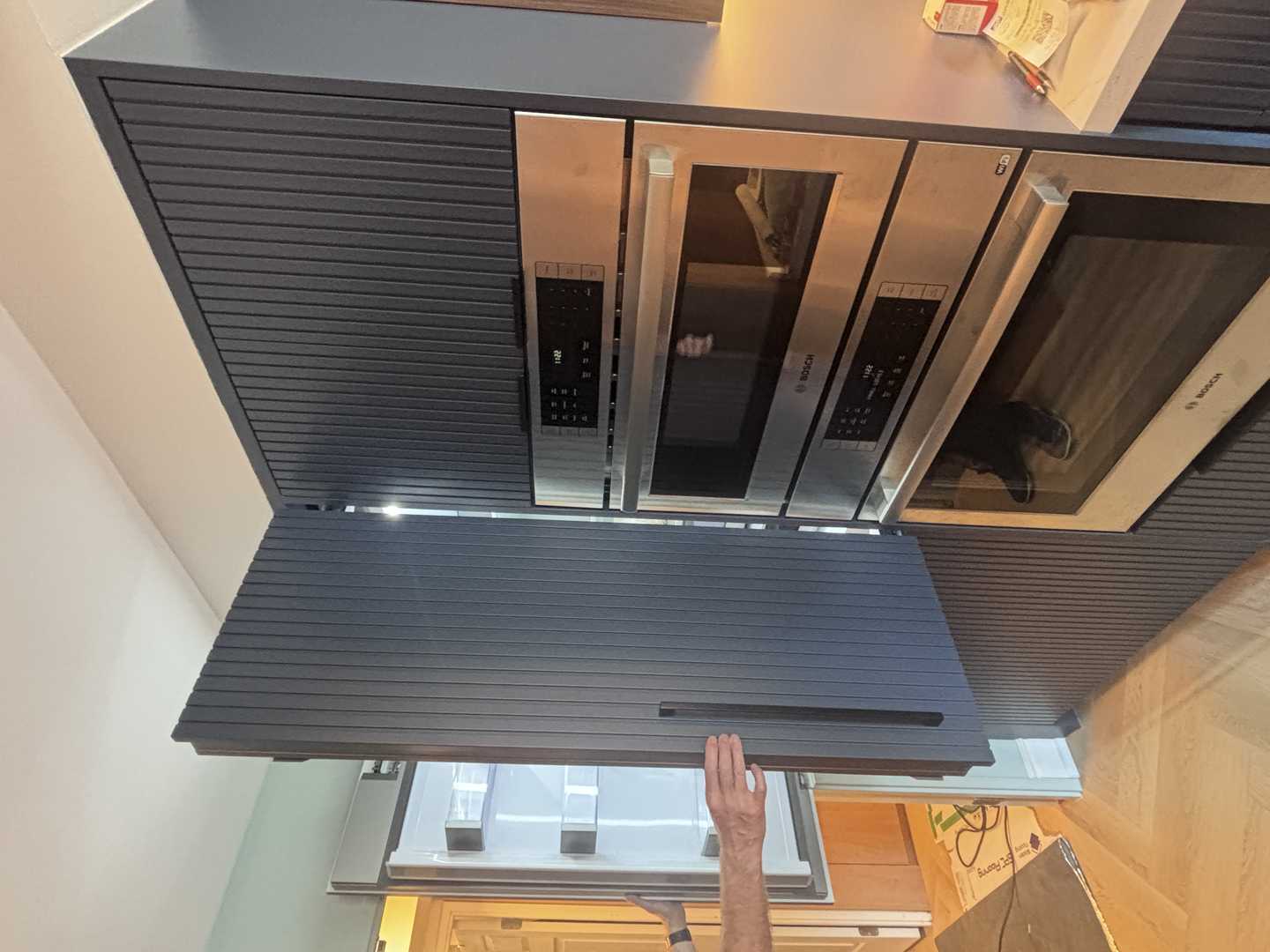 walnut wood panel with navy blue fluted kitchen, herringbone oak