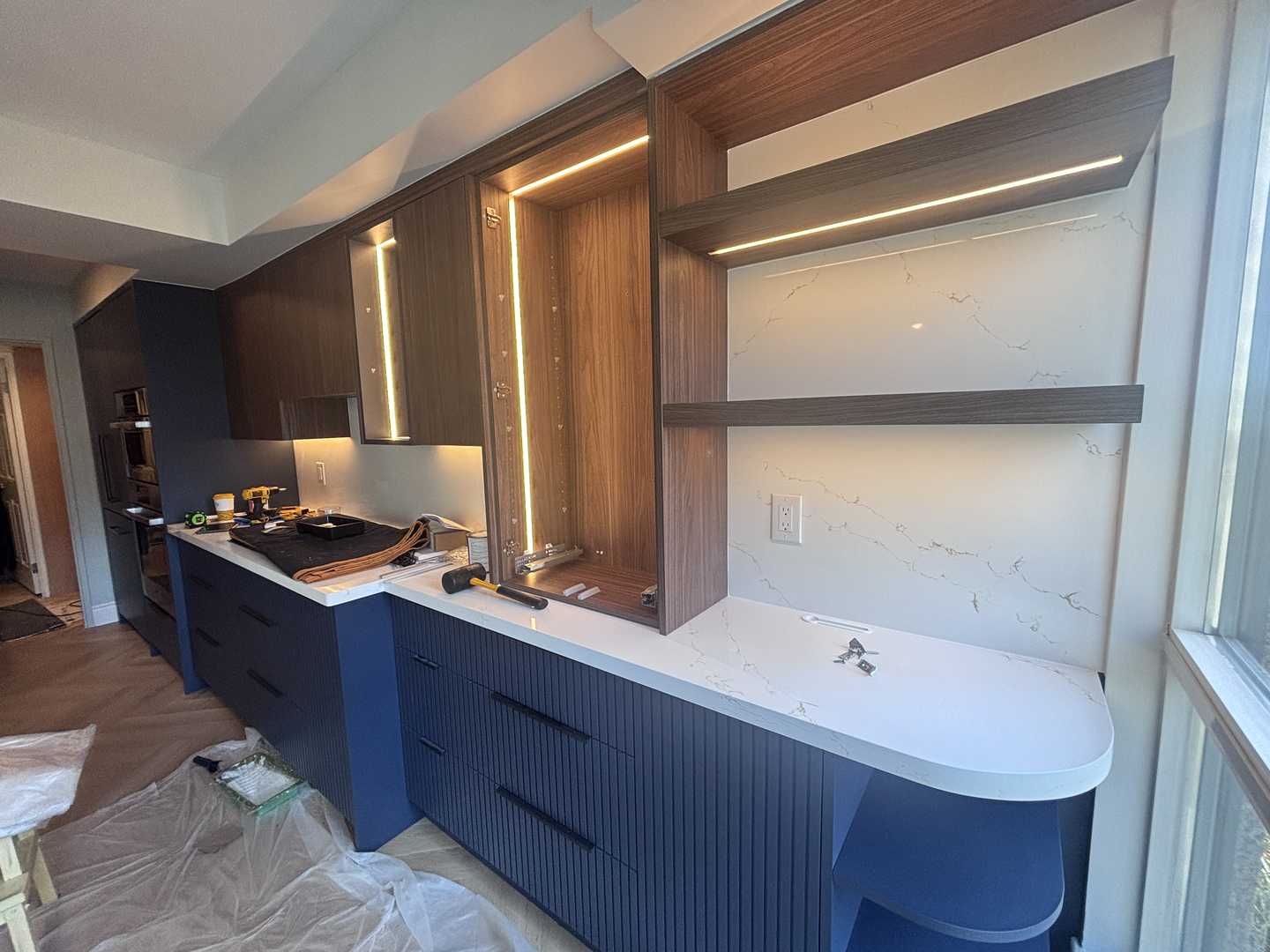 walnut wood panel with navy blue fluted kitchen, herringbone oak