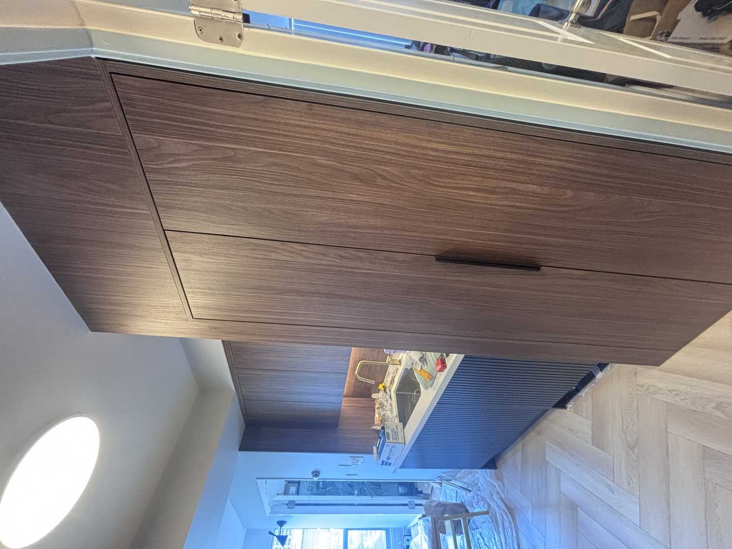 walnut wood panel with navy blue fluted kitchen, herringbone oak