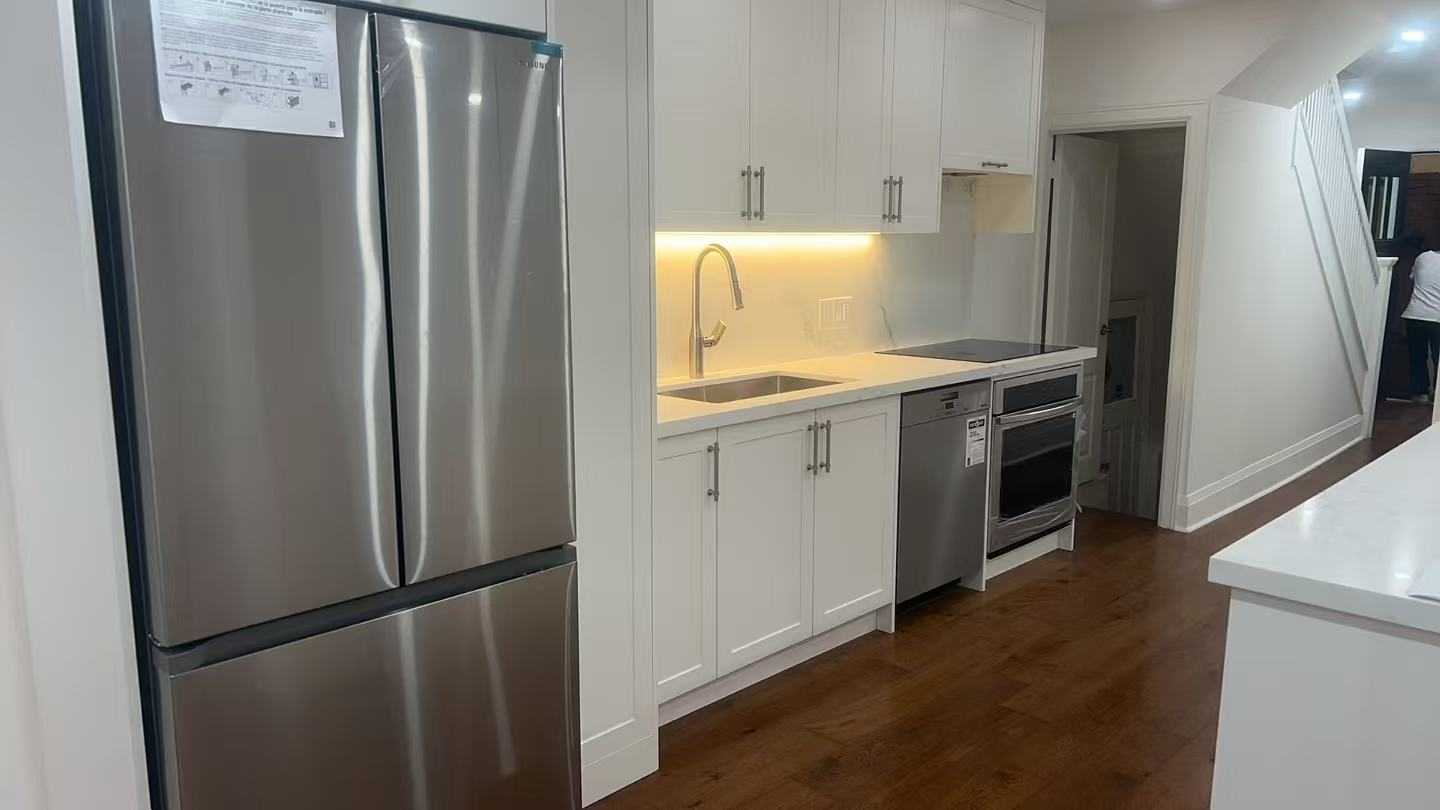 Linear White Shaker kitchen cabinet with striped light above the