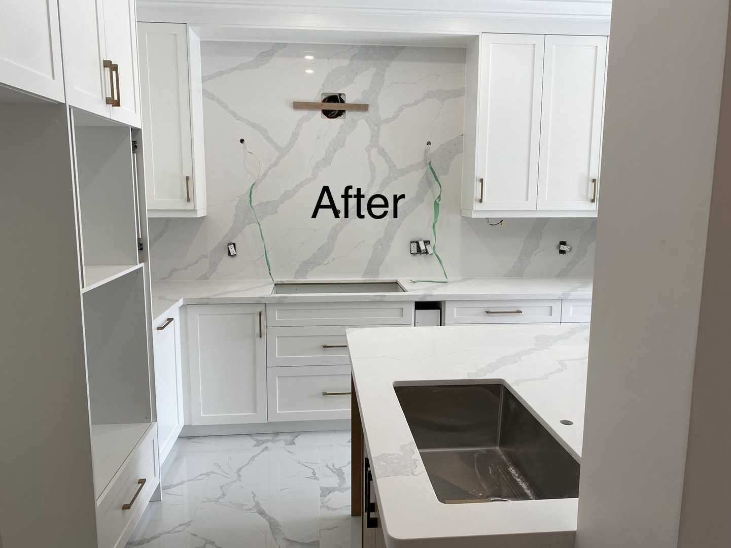 L shaped kitchen- white wood panel cabinet with dark wood