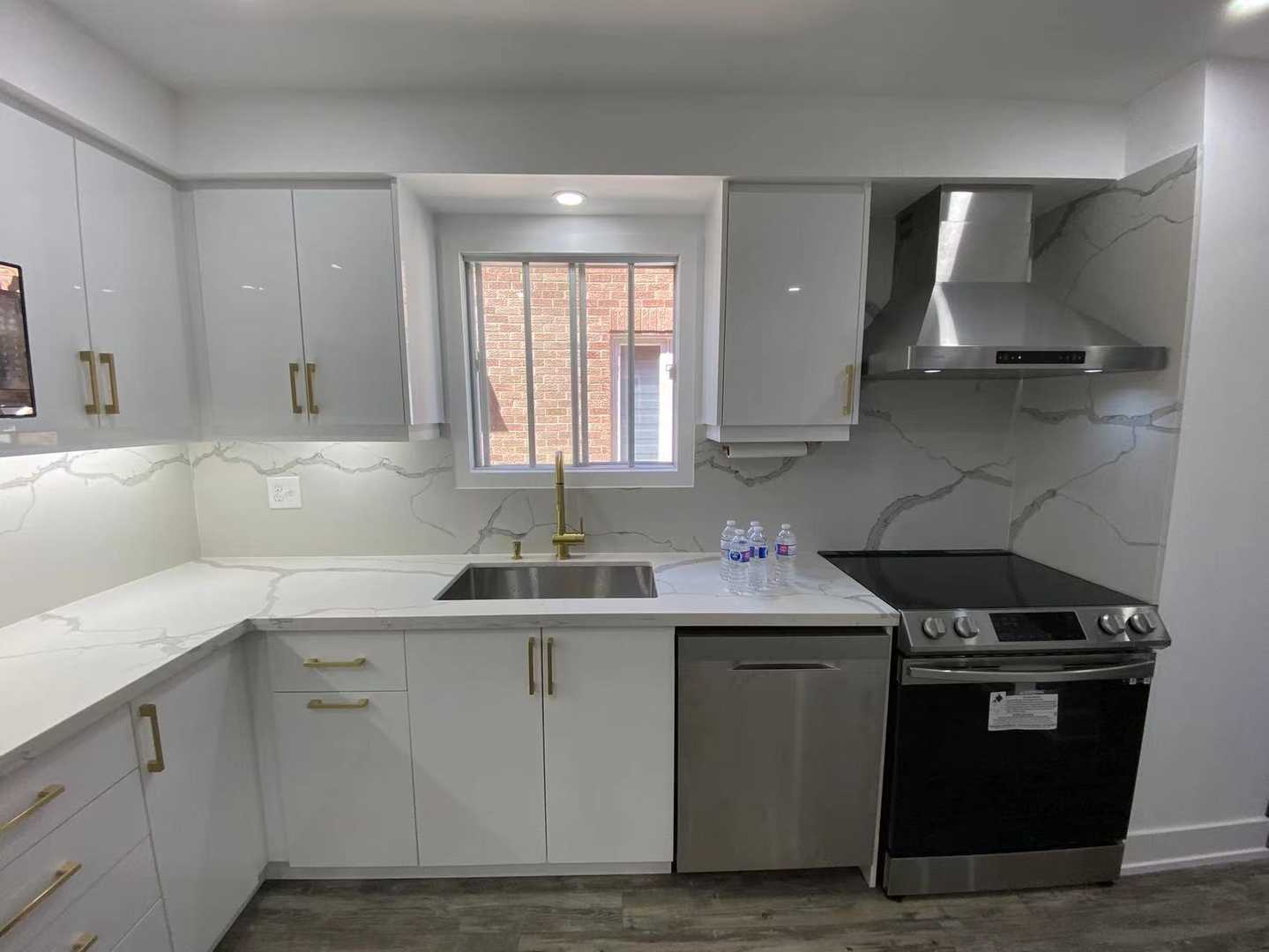 Polished white kitchen cabinets with gold hardware