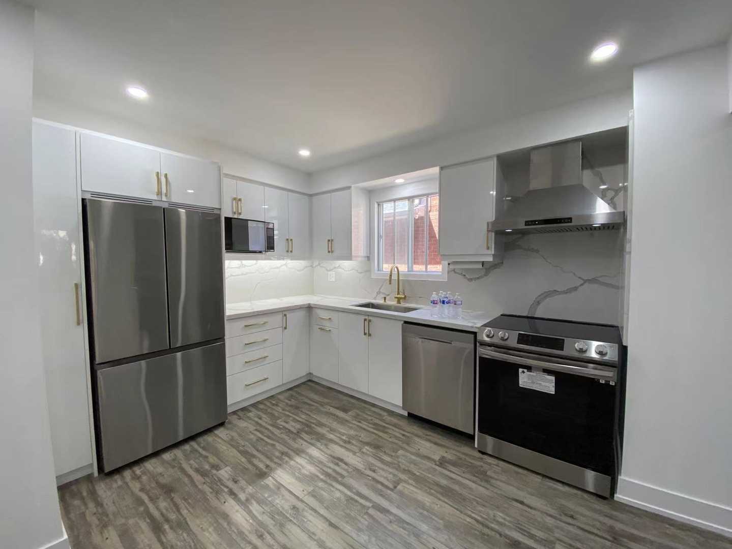 Polished white kitchen cabinets with gold hardware