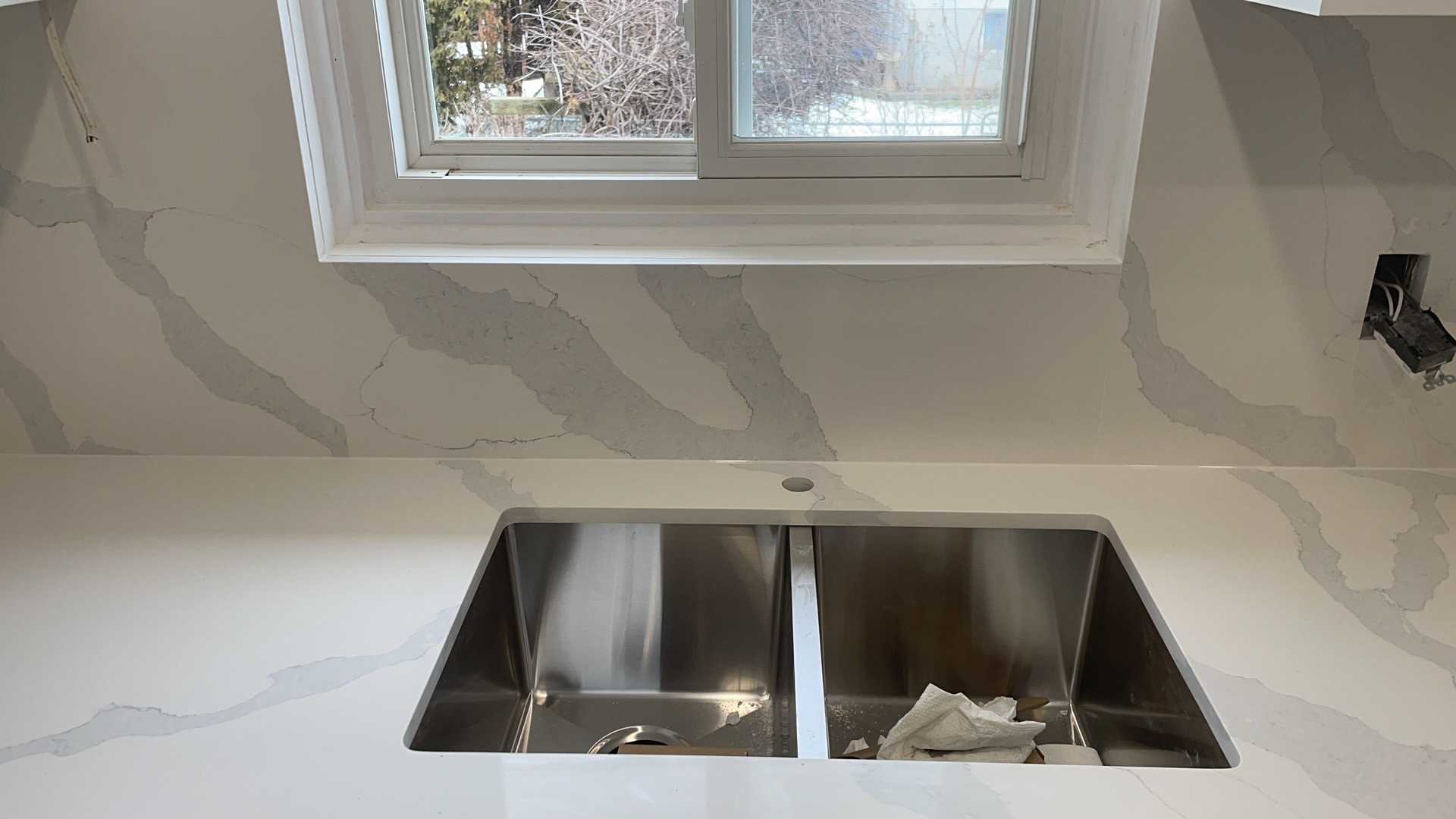 White upper cabinets with medium grey lower cabinets in a modern Whitby kitchen