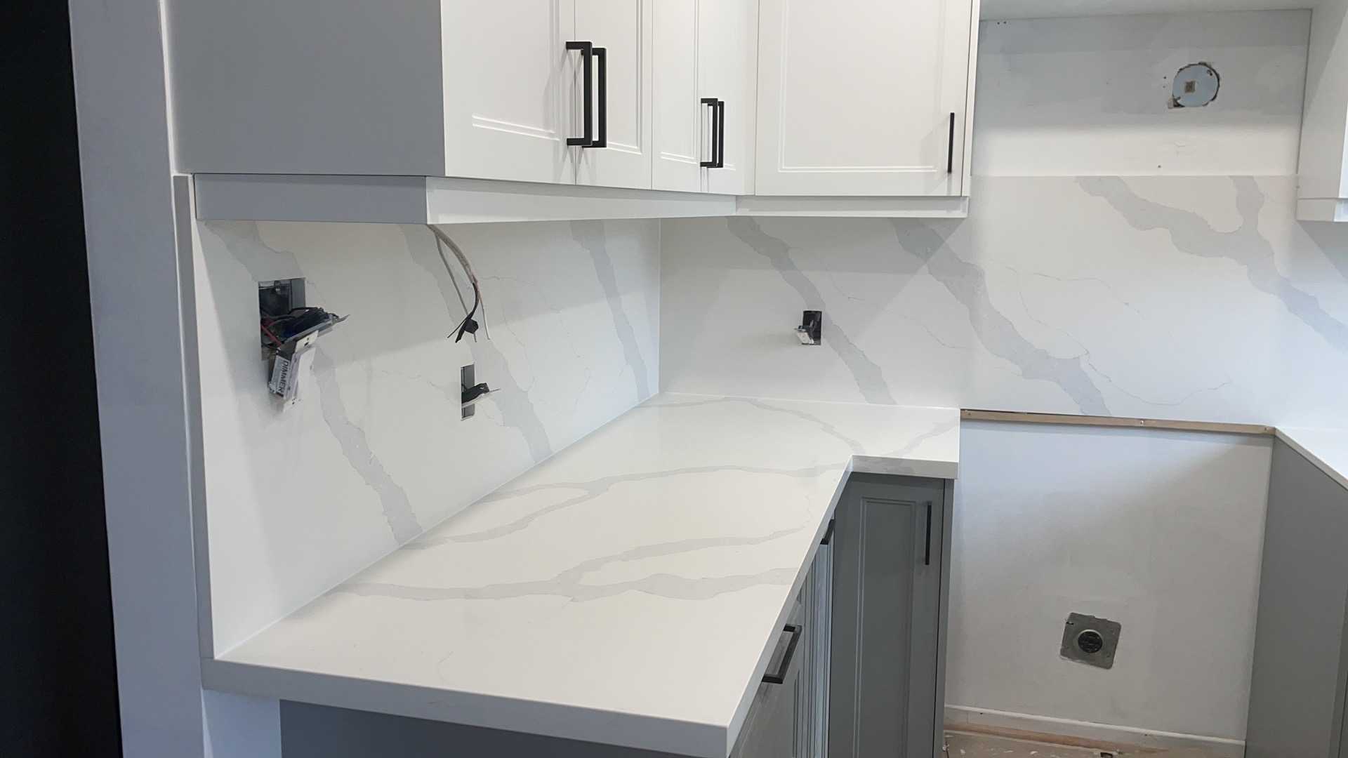 White upper cabinets with medium grey lower cabinets in a modern Whitby kitchen