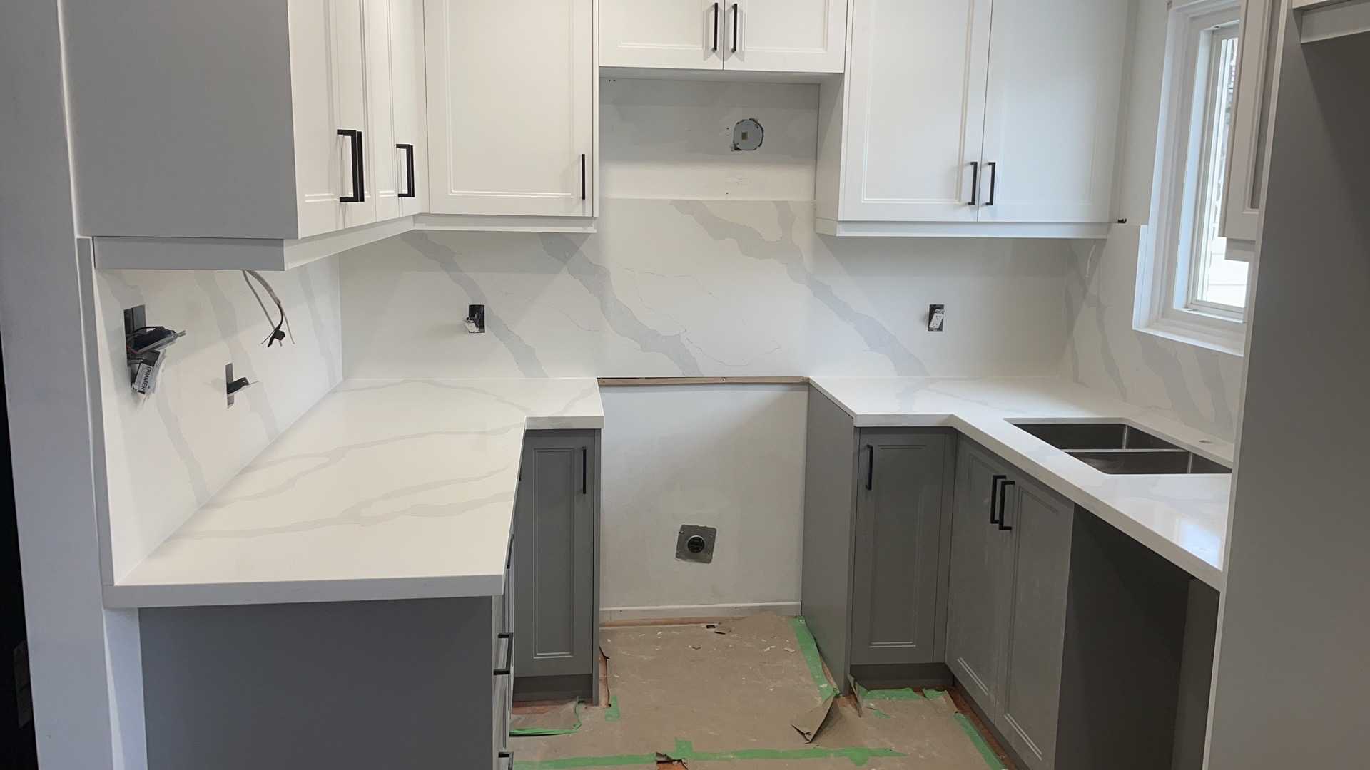 White upper cabinets with medium grey lower cabinets in a modern Whitby kitchen