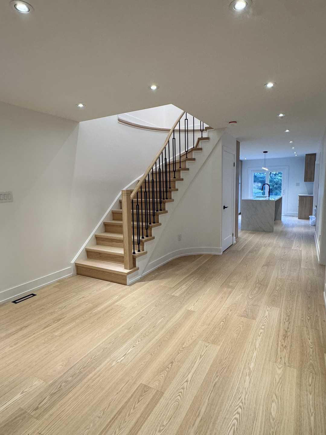 Whole-house floor renovation, including the staircase finished in natural wood