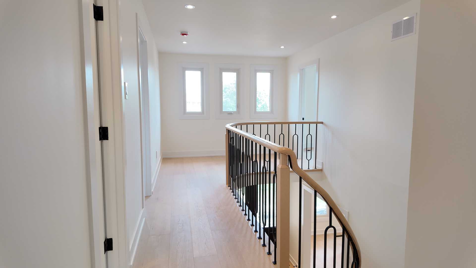 blonde wood flooring, with smooth rounded handrail