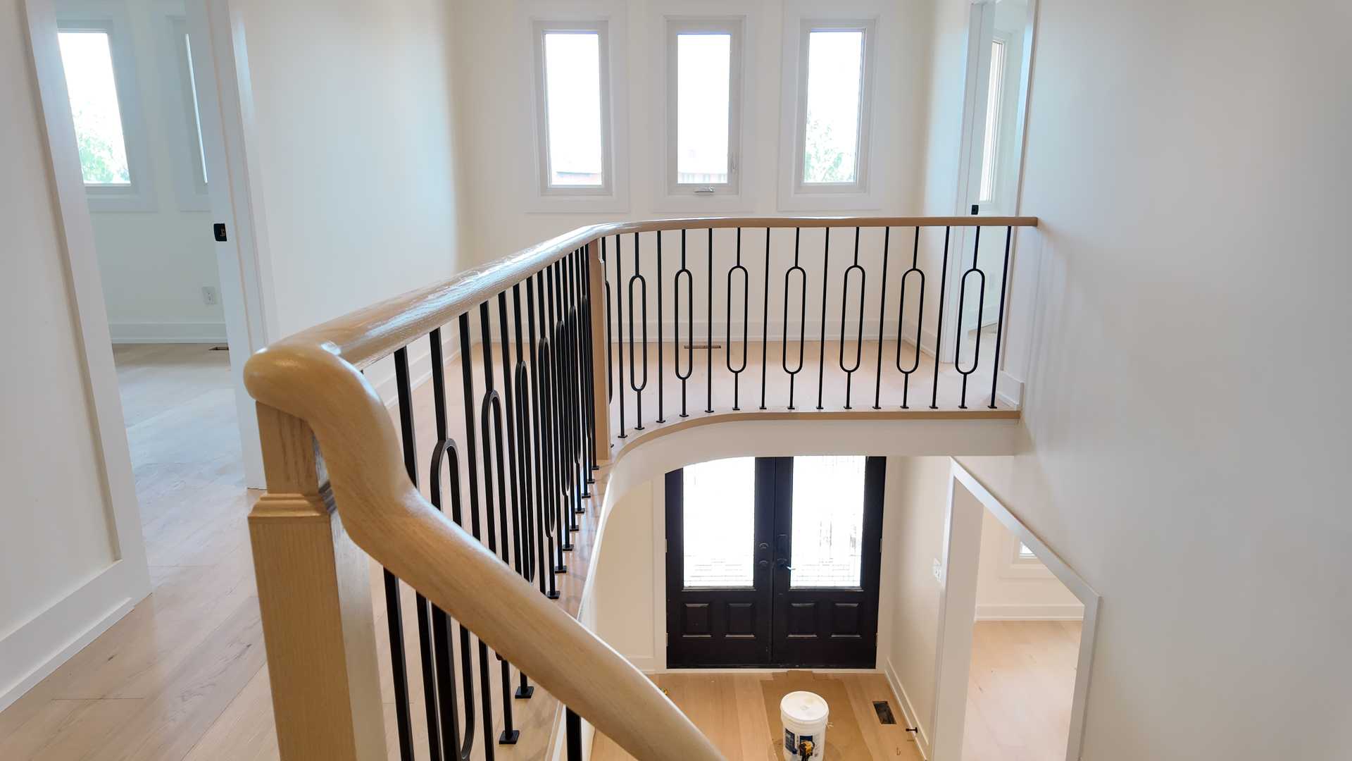 blonde wood flooring, with smooth rounded handrail