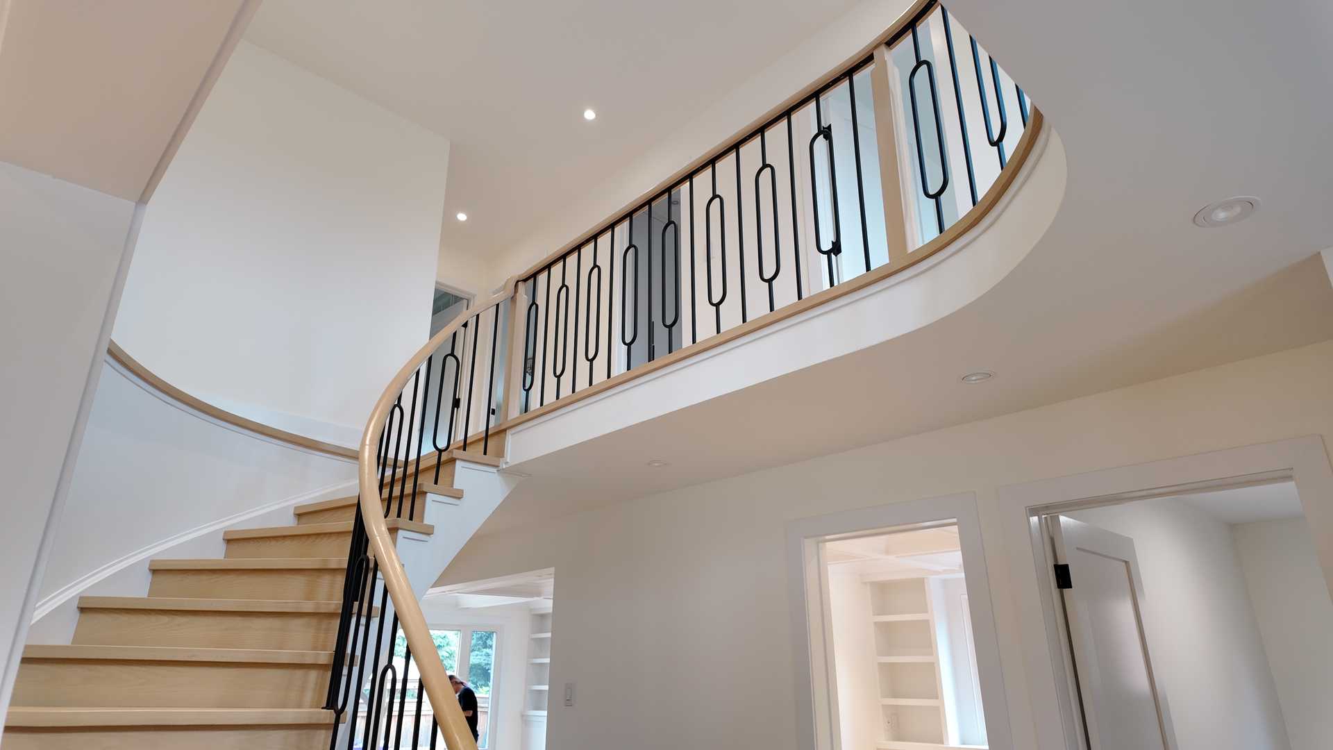 blonde wood flooring, with smooth rounded handrail