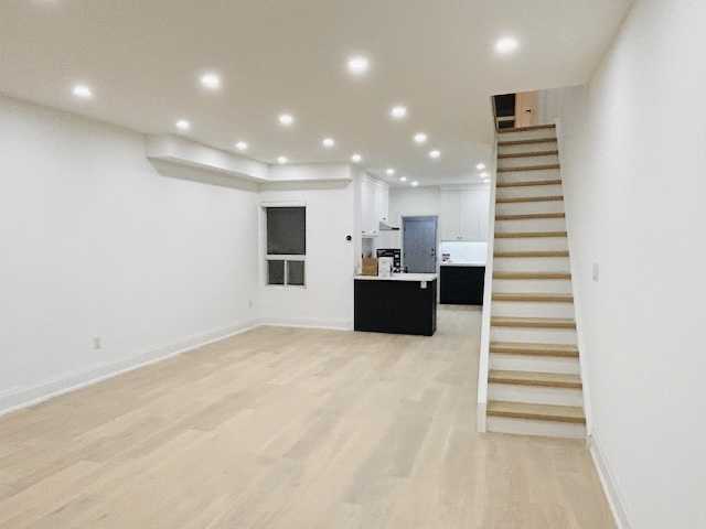 Medium-tone wood coloured hardwood flooring with glass partitions