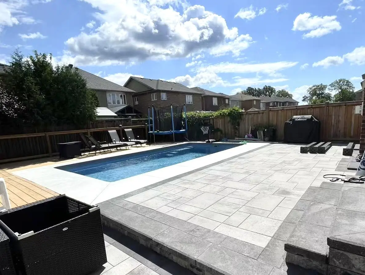 North York stone patio with seating wall and low-voltage path lights